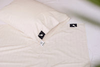Coin du drap de mise à la terre Earthle avec l'étiquette de marque et le bouton pression pour le câble